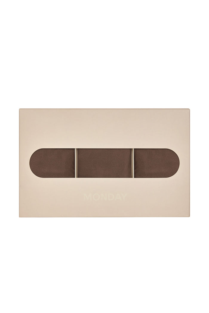 Front view of Monday G String 3-pack in mocha showing three folded g-strings visible through a beige box window with MONDAY logo