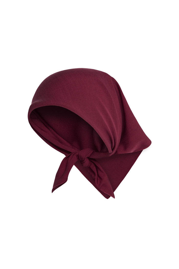 Angled view of Monday Headscarf in Fig showcasing tied knot and soft drape on white background
