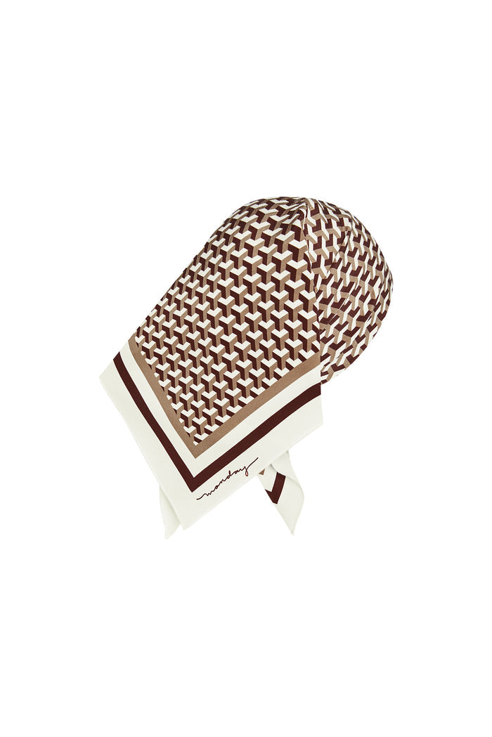 Angled back view of Monday head scarf, Husk Geo Silk, showing brown geometric print and cream-brown border on white background
