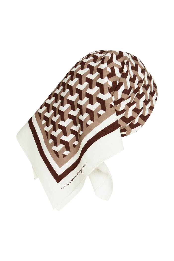 Close up of Monday Head Scarf in Husk Geo showing brown and tan pattern and corner monday signature on white background