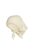 angled view of Monday headscarf in ivory rayon tied in a front knot on white background