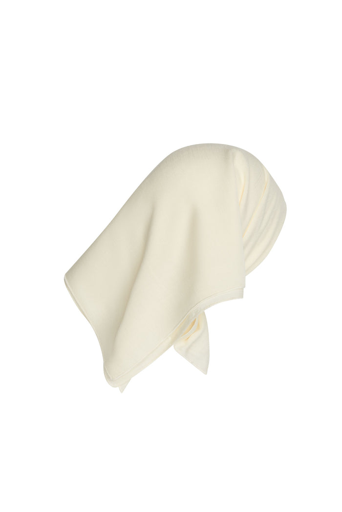 Angled view of Monday Headscarf in ivory rayon showcasing square shape and soft drape on white background