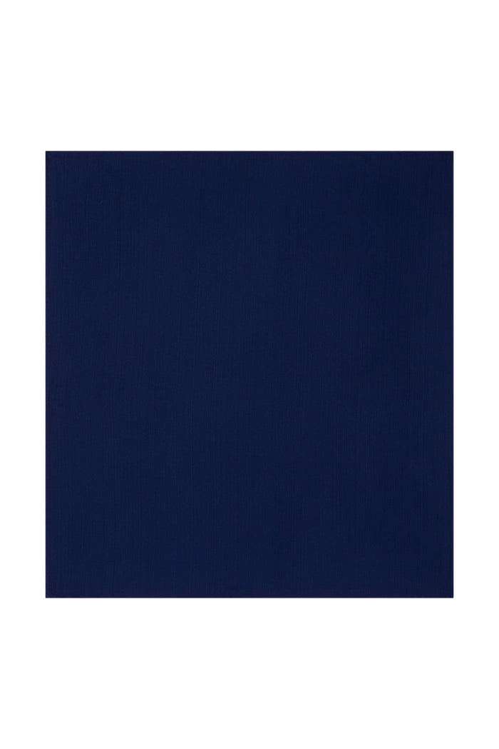 Flat lay of Monday Head Scarf in Midnight showing square shape and solid navy color on white background