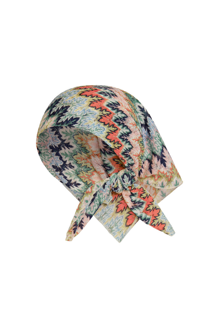 Front-right view of Monday Head Scarf Porto Cervo Multi showcasing multicolor leaf-and-zigzag print and tied front knot on white background