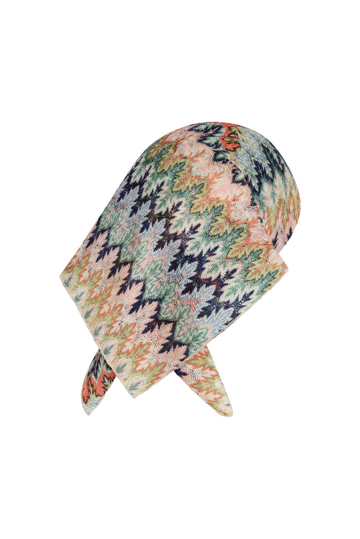 Angled close-up of Monday Head Scarf Porto Cervo Multi showcasing multicolored leaf pattern and textured knit on white background
