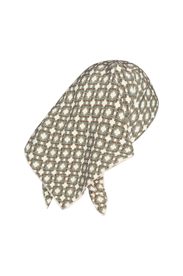 Back view of Monday Head Scarf Tile Geo Silk showing cream and tan tile-geo pattern and tied ends on white background
