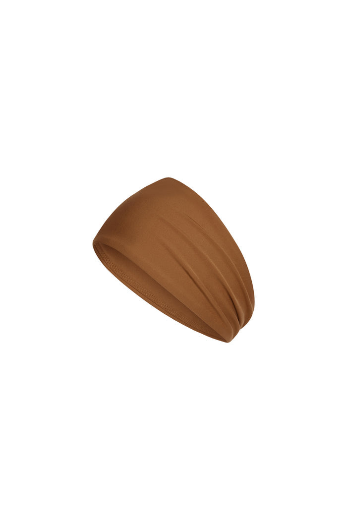 Angled close-up of Monday Headband in Caramel showcasing wide silhouette and swim fabric on white background