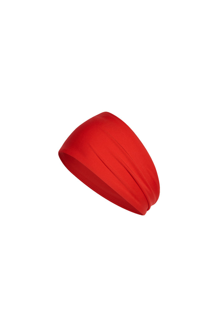 Angled front view of Monday Headband in Chili Pepper showcasing wide silhouette and swim fabric on white background