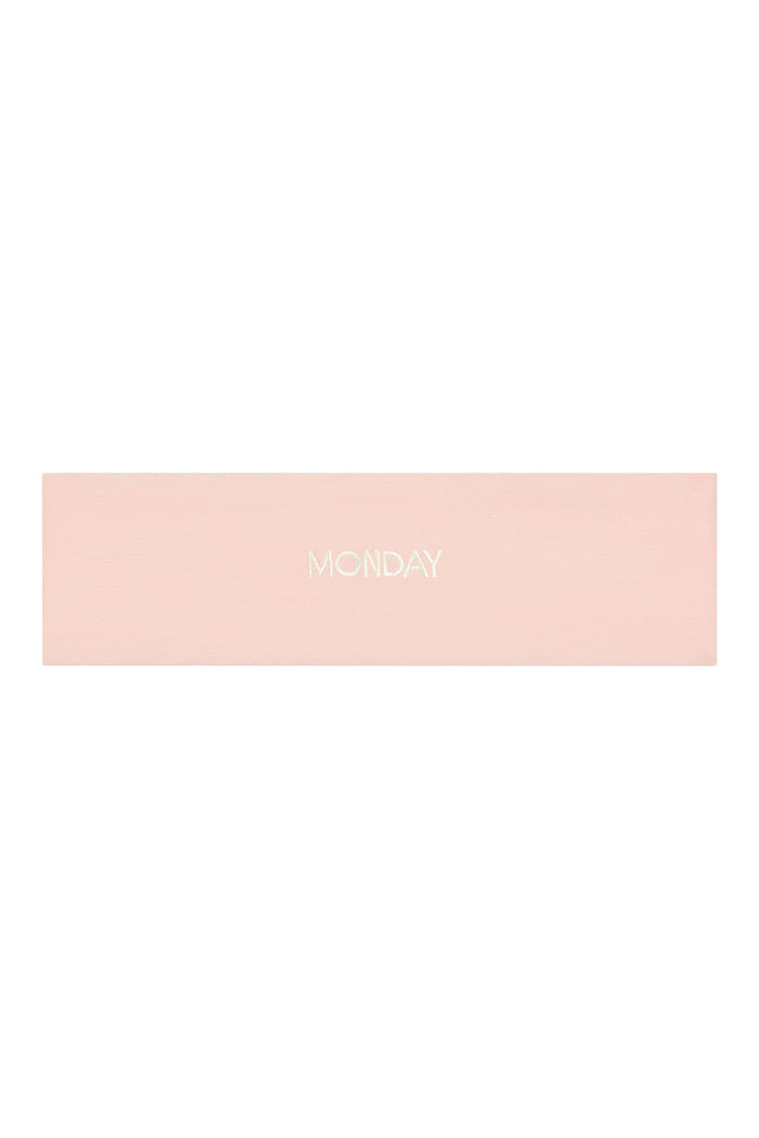 Flat lay of Monday Headband in Heather Powder Pink showcasing centered embroidered “MONDAY” logo on white background