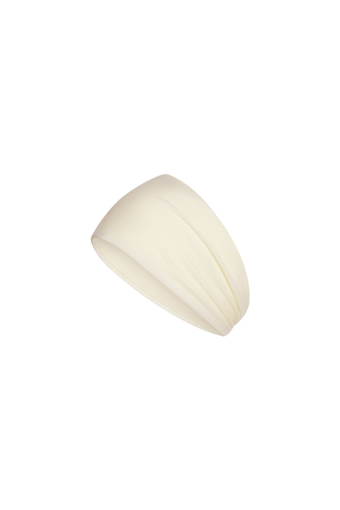 Angled close up of Monday Headband in ivory showcasing wide silhouette in swim fabric on white background