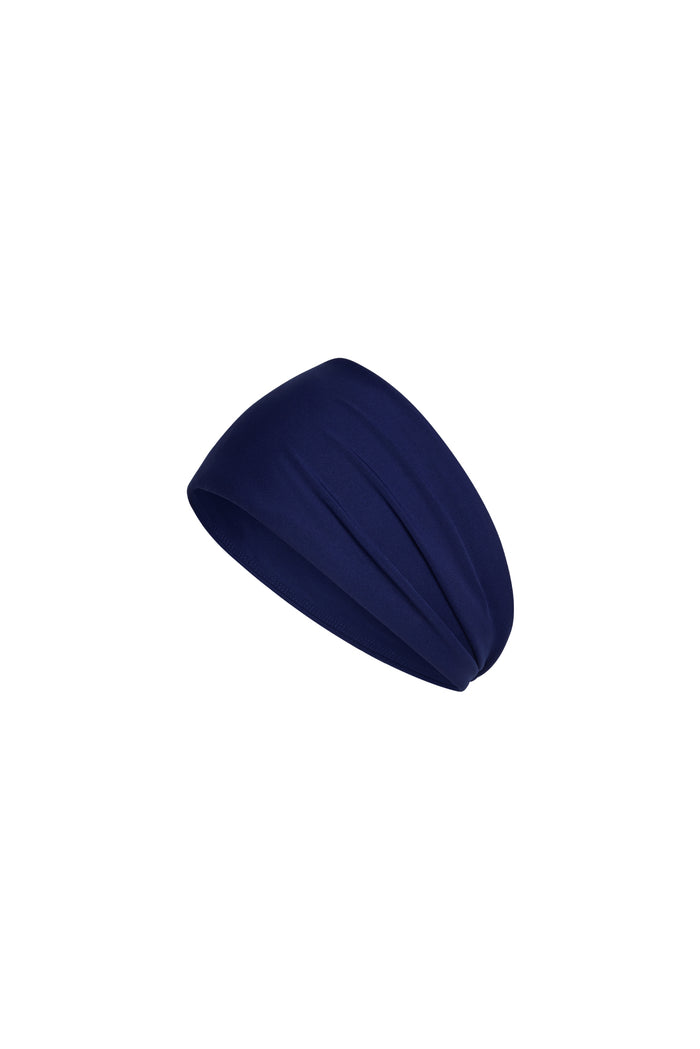 Angled close-up of Monday Headband in Midnight showcasing wide swim-fabric silhouette on white background