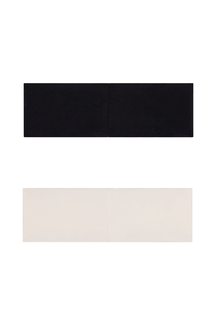 Flat lay of Monday Headband Set in Black and Ivory showing two bandeau headbands with a vertical center seam on white background