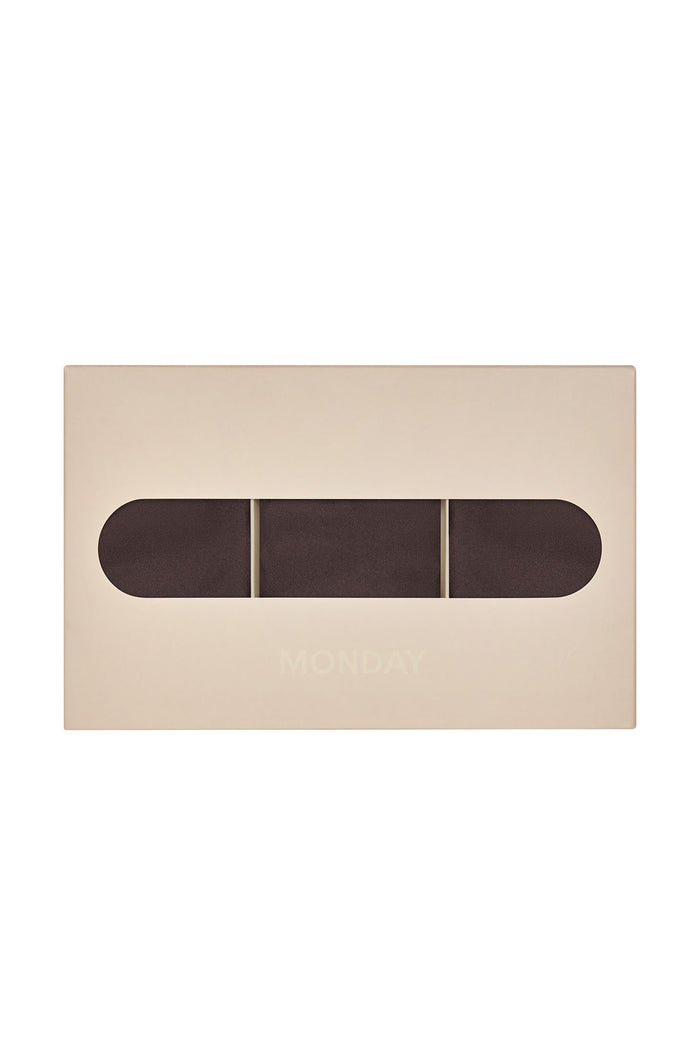 Top-down view of Monday Invisible Thong 3-pack in Clove showing three mid-rise raw-edge thongs in a beige box on white background