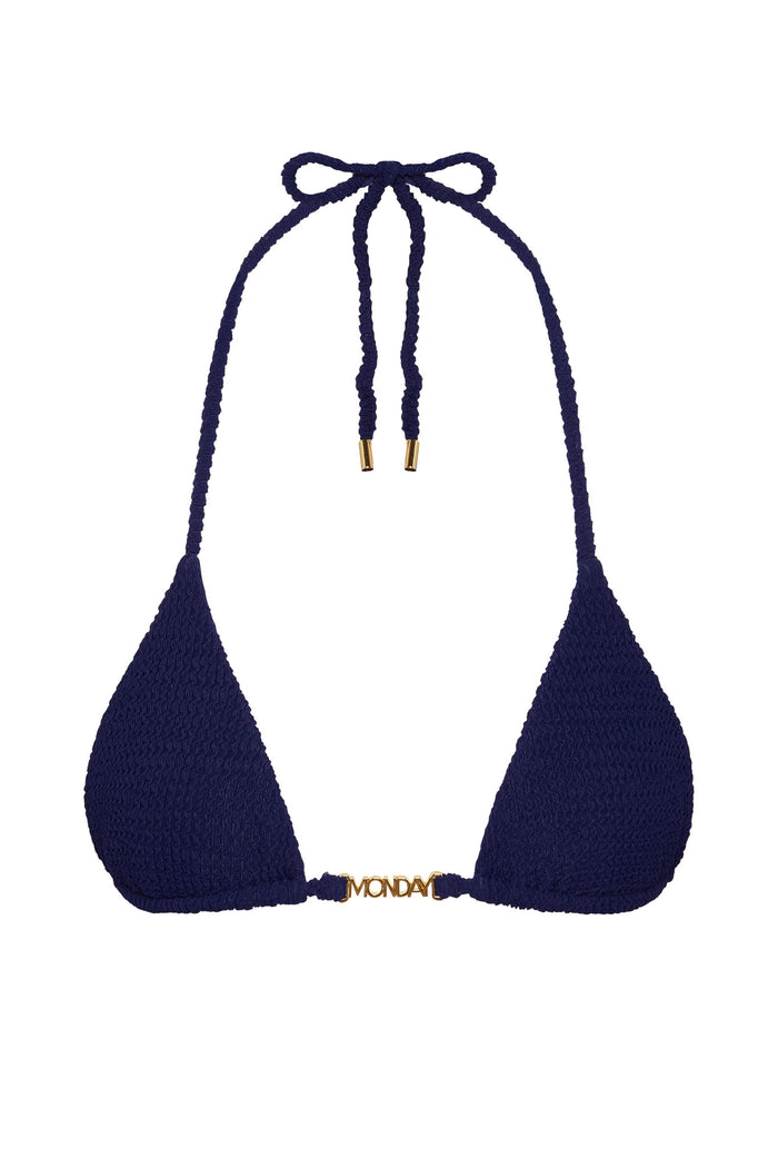 Flat-lay of Monday Top bikini in Midnight Crinkle showing triangle cups, halter ties, and gold MONDAY logo on white