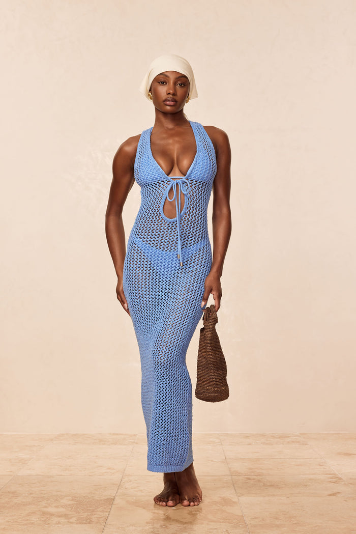 Front view of Monte Carlo Tie Dress in azure crochet with plunging neckline, tie and semi-sheer knit on beige background