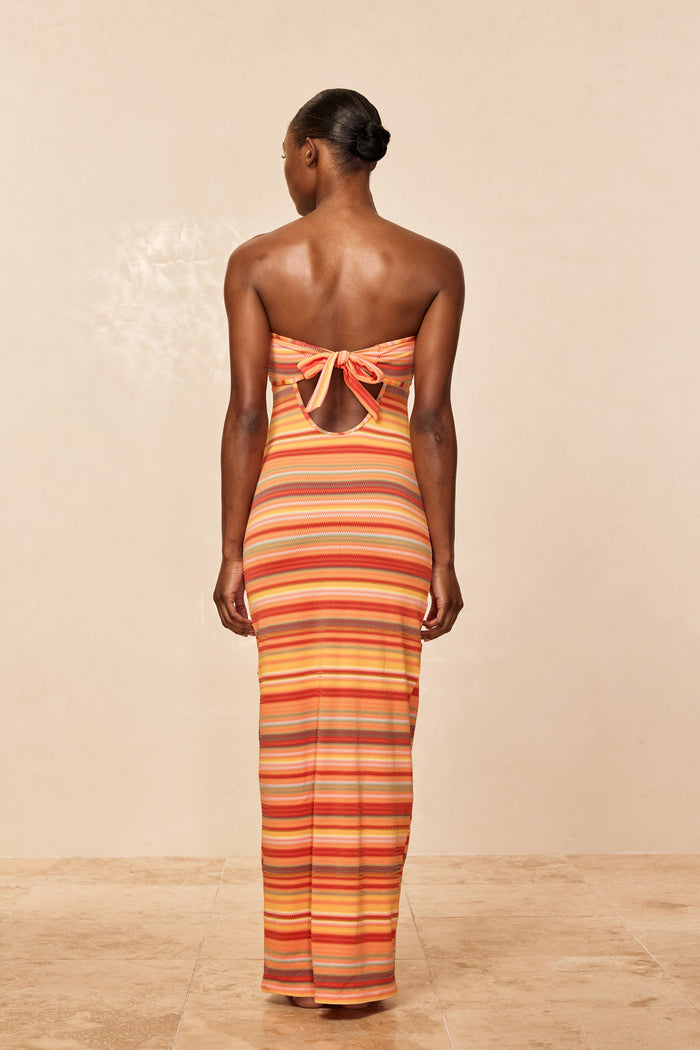 Back view of Montego Bandeau Dress in Sardinia Stripe showing tied bandeau and keyhole back on beige background