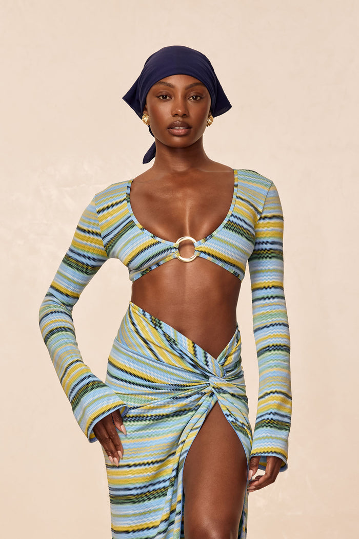Front view of Montego Crop Top in Sardinia Stripe Azure showcasing long sleeves, center metal ring and cropped fit on model with neutral studio background
