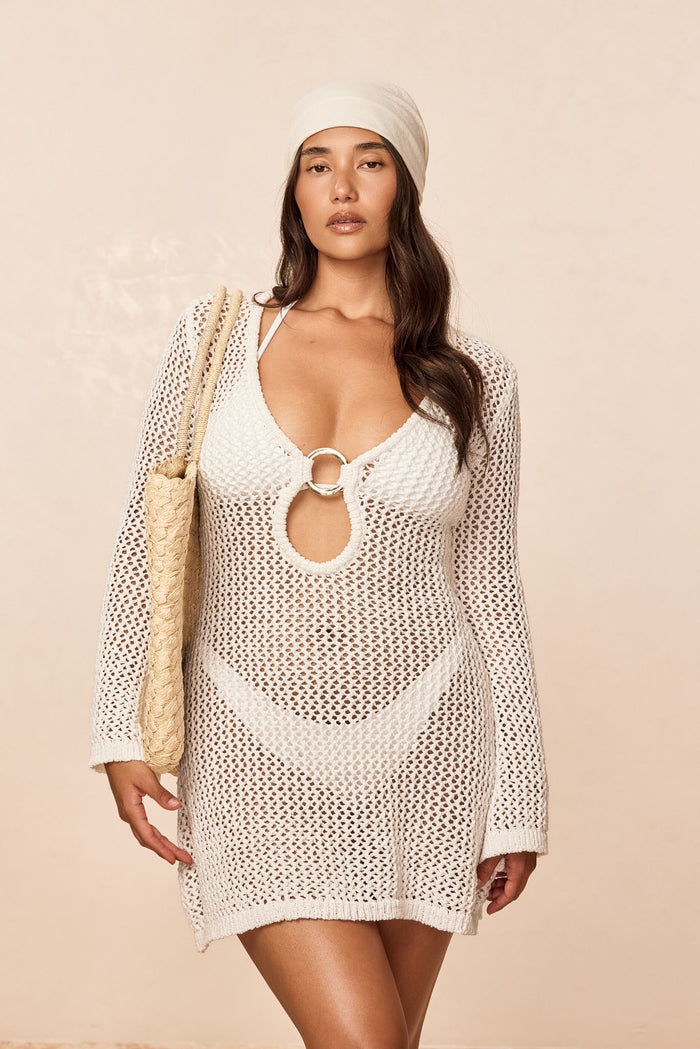 Front view of Montego Mini Dress in White Petit Crochet showing plunging neckline with gold ring and long flared sleeves
