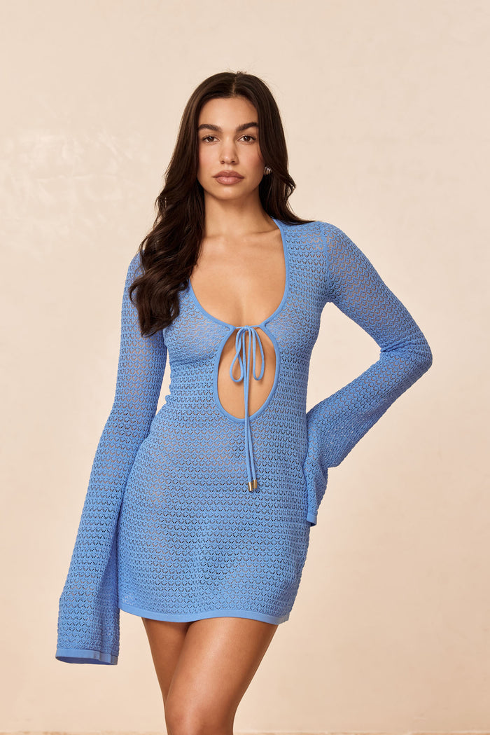 Front view of Montego Mini Tie Dress in azure lace crochet showcasing front tie keyhole, bell sleeves and mini hem on neutral backdrop