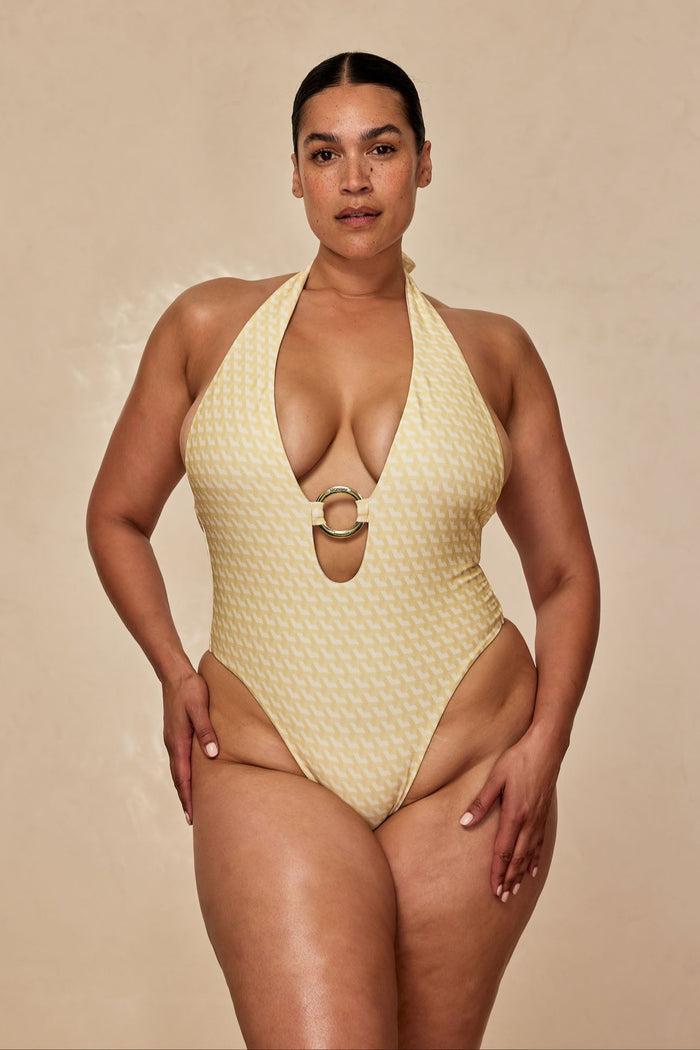 Front view of Montego One Piece in Ivory Geo on model; plunging halter neckline with gold center ring and high-cut leg