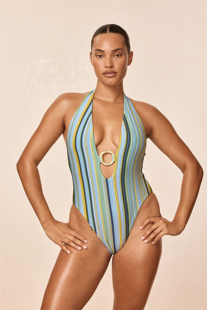 Front of Montego One Piece, Sardinia Stripe Azure, deep halter plunge with gold ring and blue-green stripes on beige