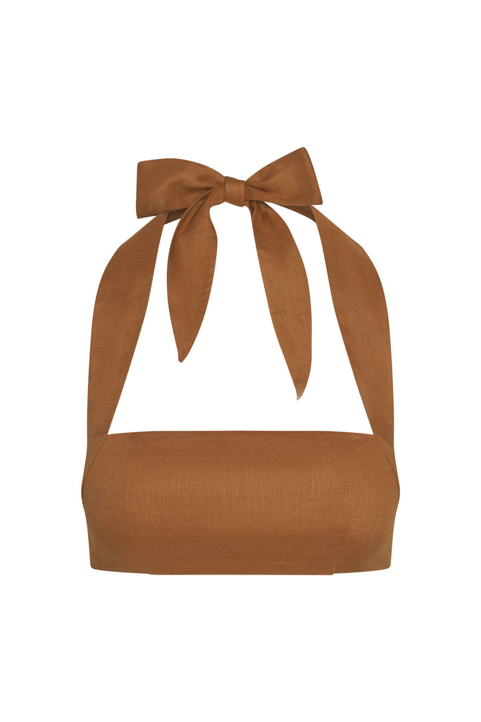 Front view of Montserrat Top in caramel linen showcasing halter tie bow and straight bandeau neckline on white background