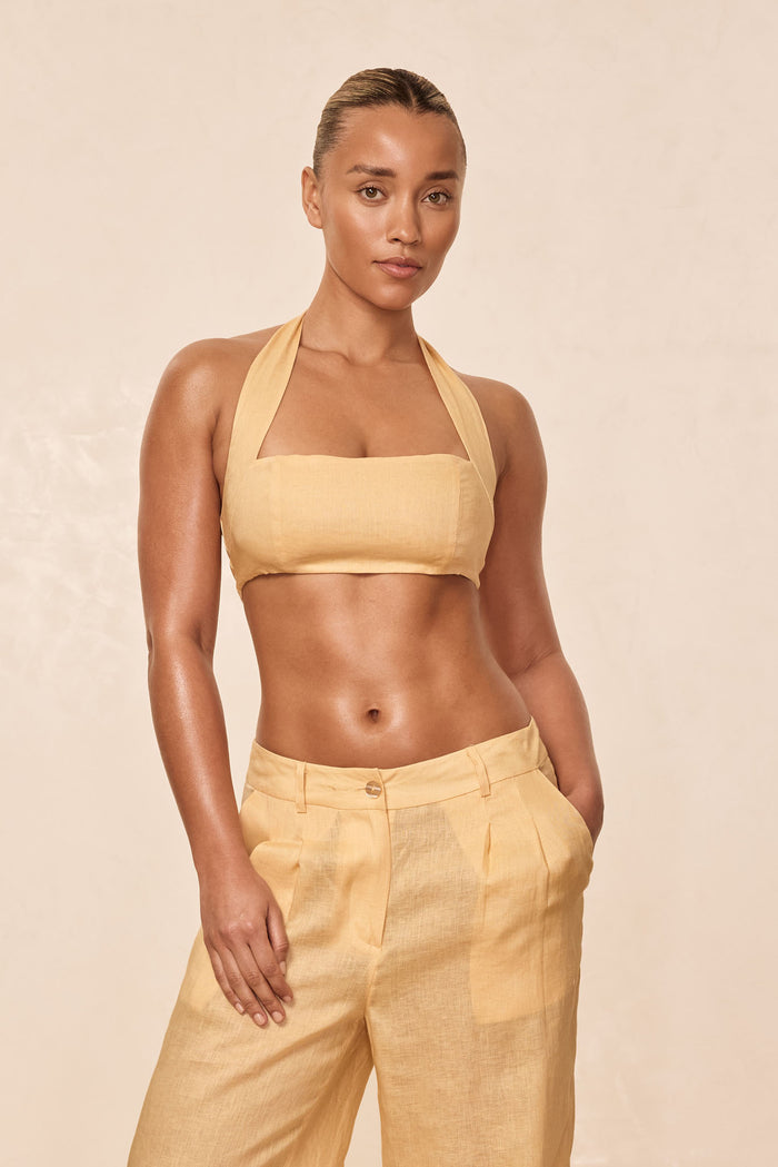 Front view of Montserrat top in raffia linen showcasing halter straps, square neckline and cropped fit on neutral background