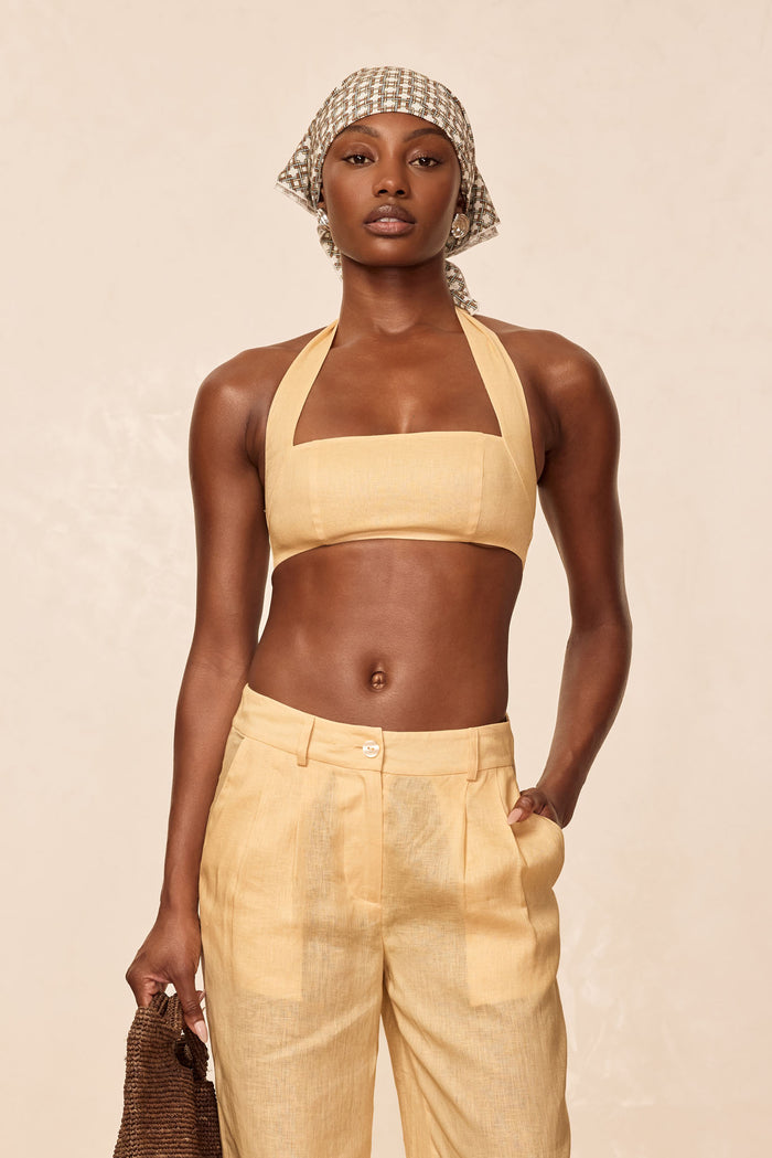 Front view of Montserrat Top in Raffia Linen showcasing square bandeau neckline, wide halter straps, and cropped fit on model