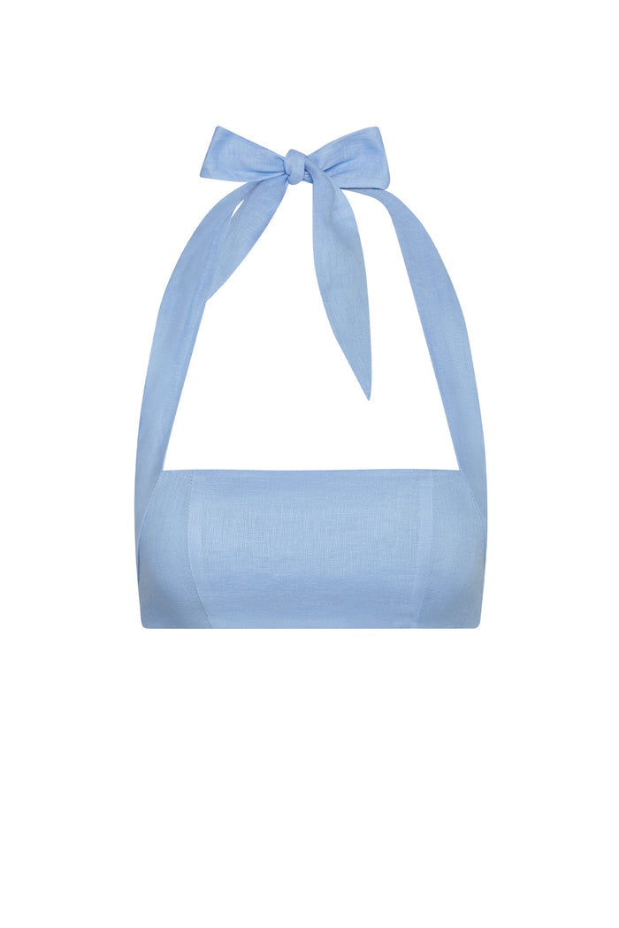 Front view of Montserrat Top in Sky Linen showcasing cropped linen bandeau with halter tie bow on white background