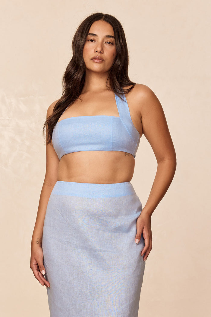 Front view of Montserrat Top in sky linen showcasing halter neckline, lined bust, and cropped fit