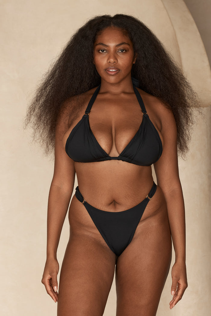 Front view of Morocco Top in black on model showcasing triangle halter shape with adjustable straps against a neutral studio background