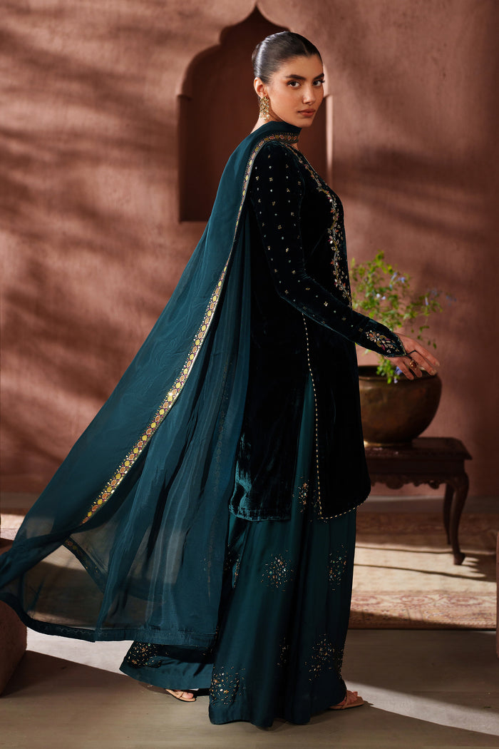 Front full-length view of NAQSHI teal green formal stitched outfit showing straight embroidered shirt and graceful fit