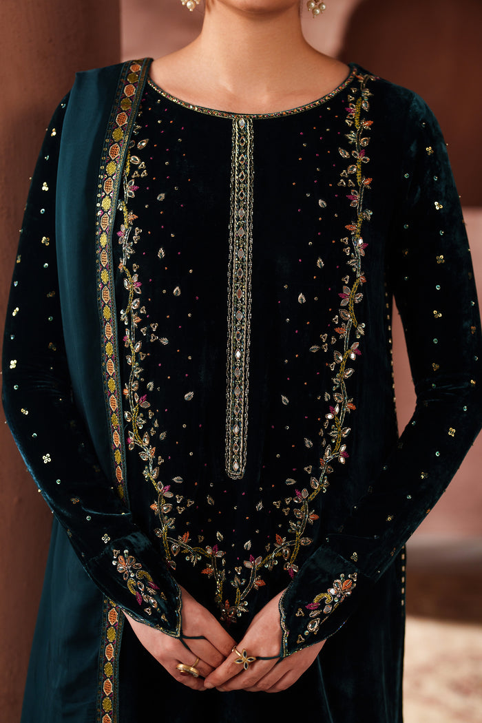 Close-up detail of NAQSHI teal green formal dress showing embroidery on neckline and front panel