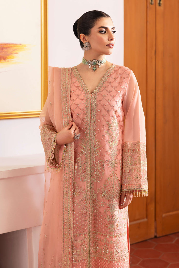 Detailed shot of NAQSHI Muzna sleeve end featuring crystal‑trimmed lace, hand‑made hangings and finely stitched embroidery on flamingo‑pink organza.