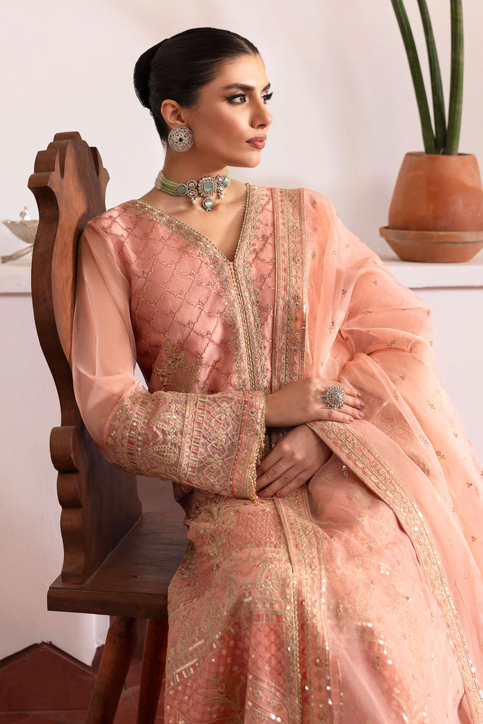 Close‑up of NAQSHI Muzna front panel detailing intricate Islamic‑Mughal embroidery, sequin work, contrasting floral motifs and border trims on organza.