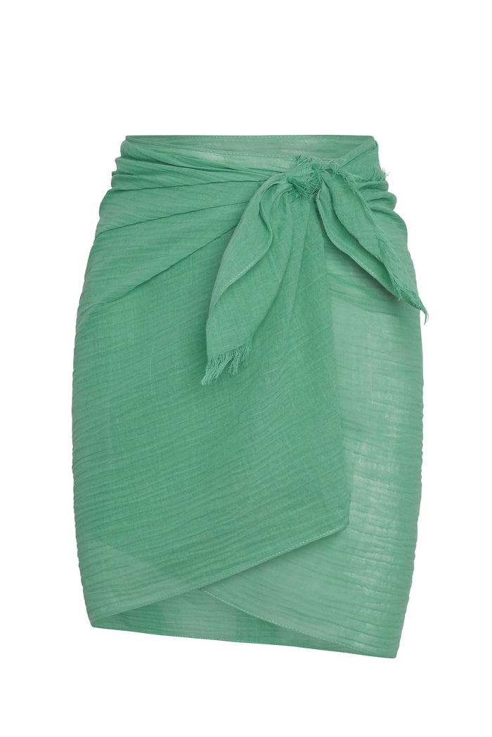 Green lightweight wrap skirt with tied side knot and frayed edges, sarong-style knee-length overlay.