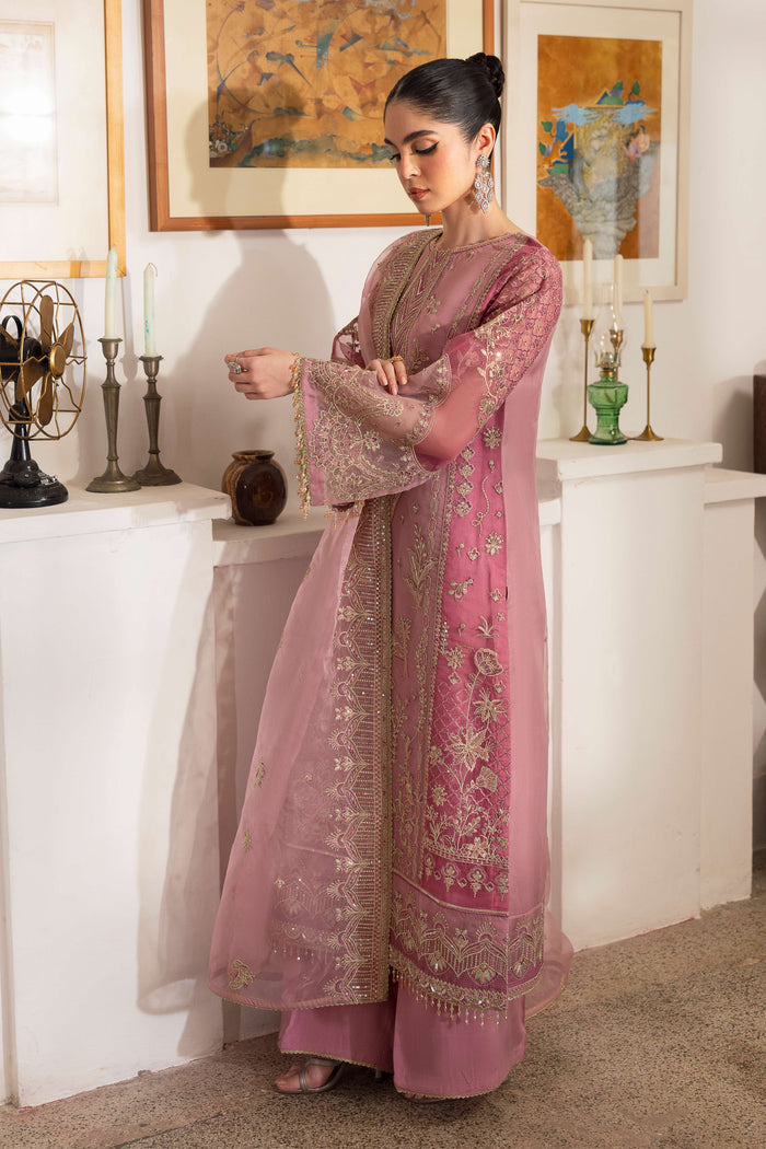 Detailed shot of NAQSHI Nayab showing berry-pink patch embroidery on side panel with textured sequin and floral motif work.