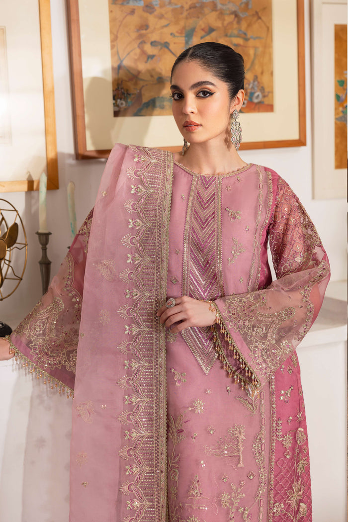 Close-up of NAQSHI Nayab sleeve cuff highlighting floral and geometric sequin embroidery on pastel organza with berry-pink patch and crystal hangings.