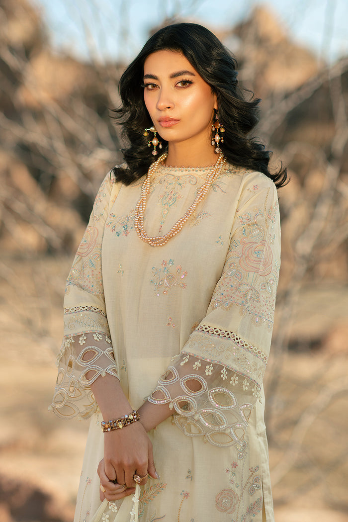 Portrait close up showing floral embroidery and organza patch details on light yellow lawn shirt