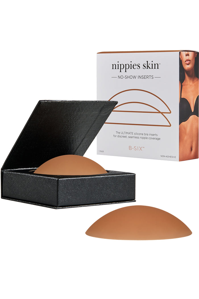 Front view of Nippies Skin silicone no-show bra inserts showing dome shape and skin-tone color with black case on white background