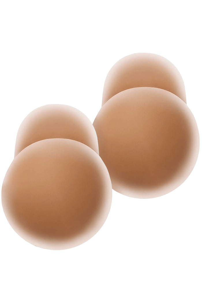 Front view of two pairs of Nippies Skin Lift nipple covers (Coco), tan adhesive pasties that provide lift on white background