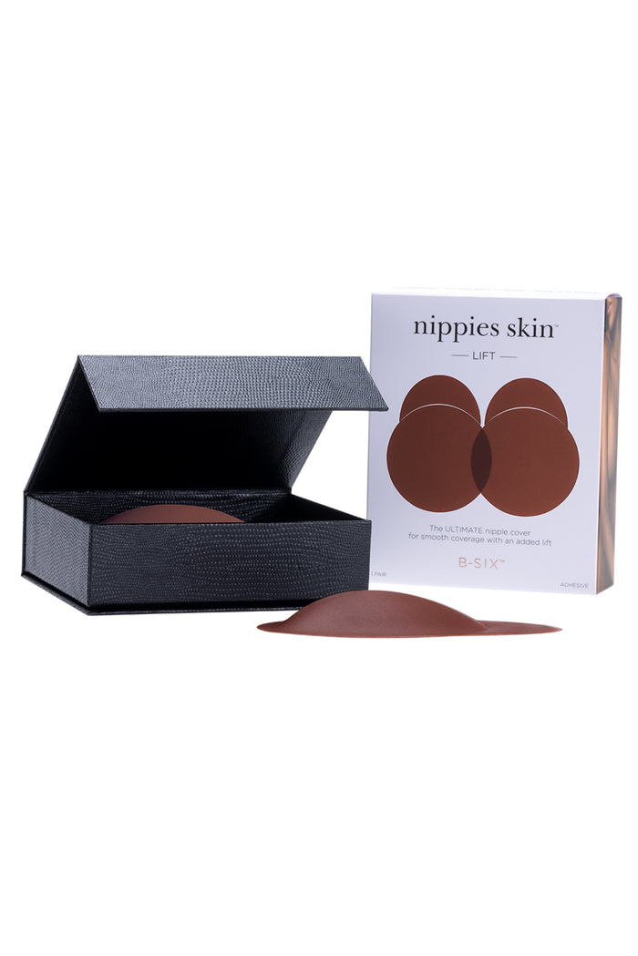 Front view of Nippies Skin Lift hazelnut silicone nipple covers showcasing domed lift shape with black storage box and product box on white background