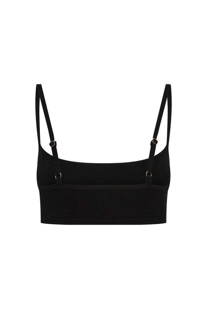Front view of Olympic Bra in black showcasing thin adjustable straps with gold-tone hardware and straight back band on white background
