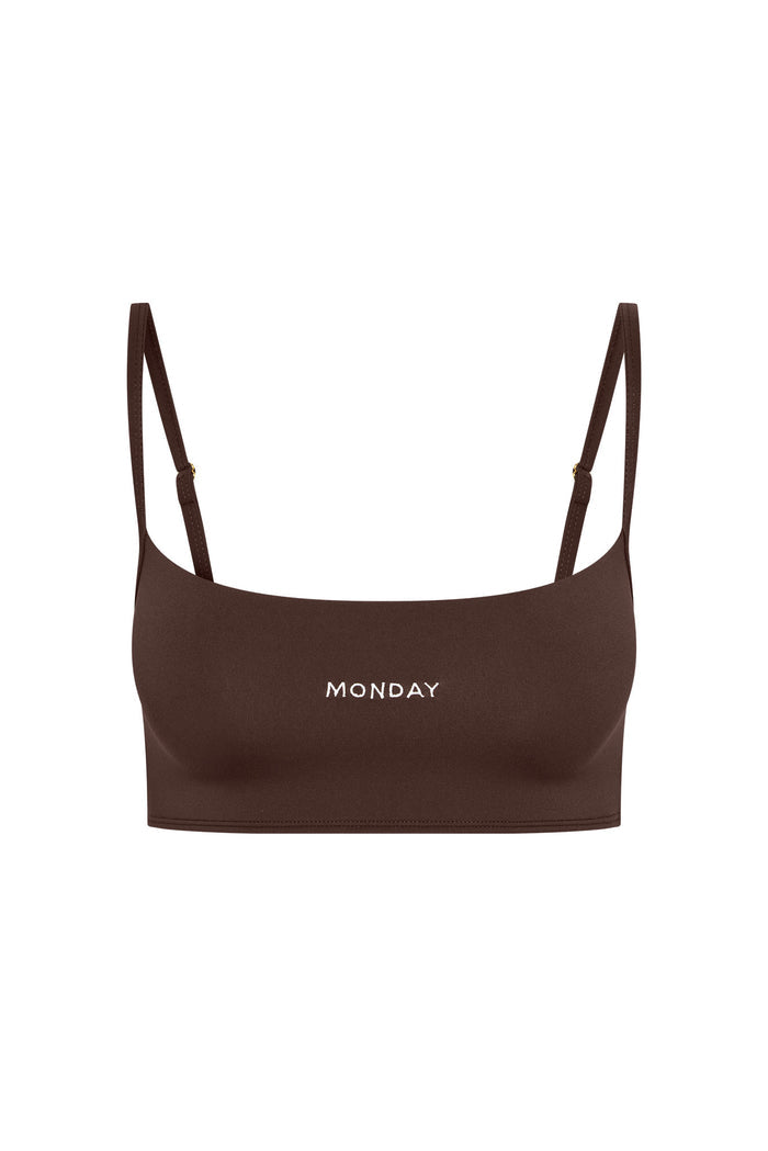 Brown cropped bralette with thin adjustable straps and MONDAY printed centered on front.