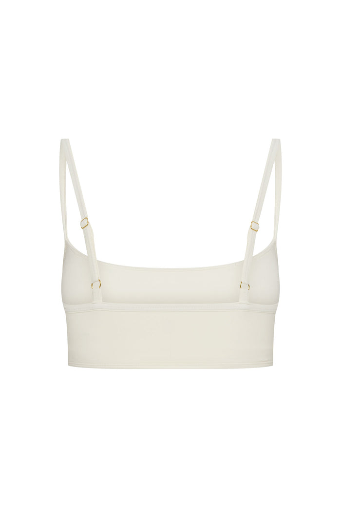 Ivory cropped bralette with adjustable thin straps and gold-tone hardware, back view.