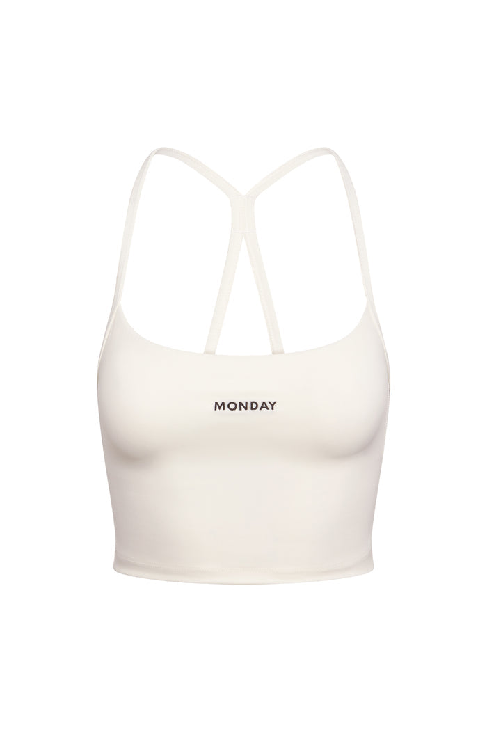 Front view of Olympic Tank in ivory showcasing cropped fit, thin double racerback straps and centered MONDAY logo on white
