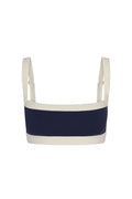 Front view of Outpost Bra with square neckline, midnight navy center and ivory trim, adjustable straps on white