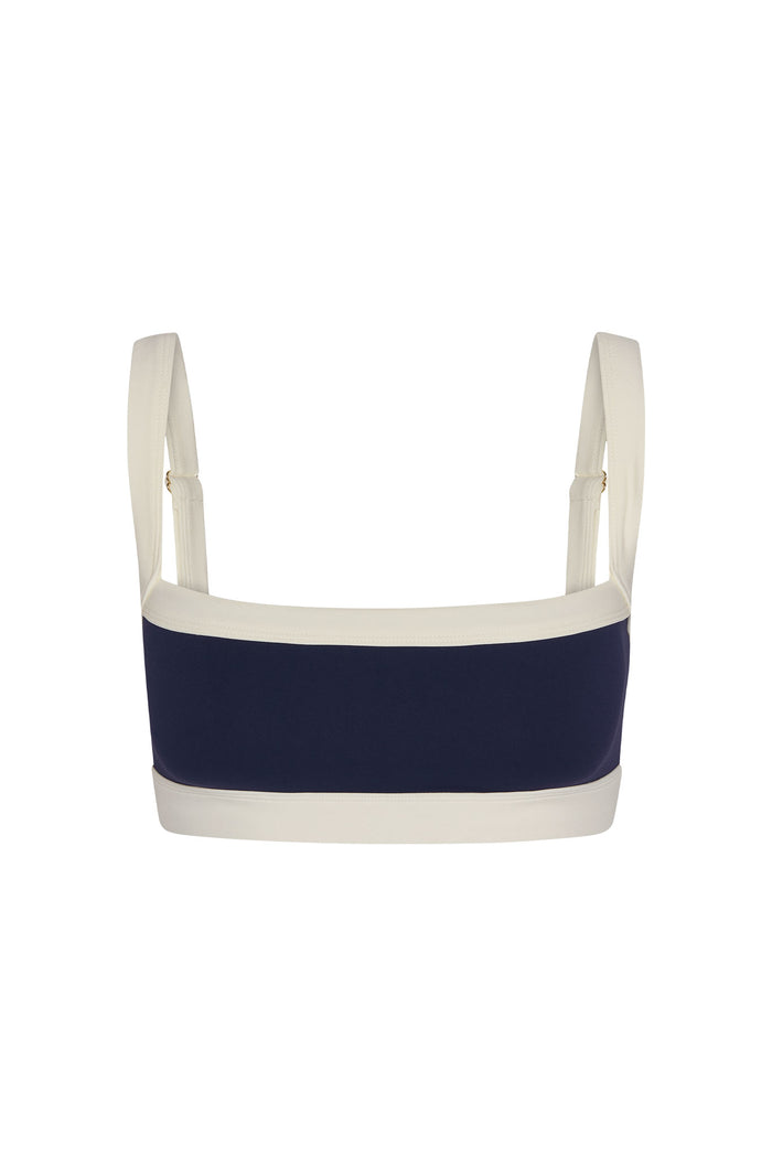 Front view of Outpost Bra with square neckline, midnight navy center and ivory trim, adjustable straps on white