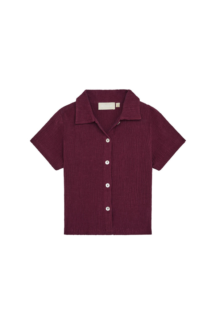 Front view of Pacific Beach Shirt Kids showcasing fig crinkle fabric, short sleeves and camp collar on white background