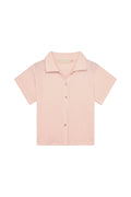 Front flat lay of Pacific Beach Shirt Kids showcasing powder pink crinkle texture, short sleeves and button-front on white background